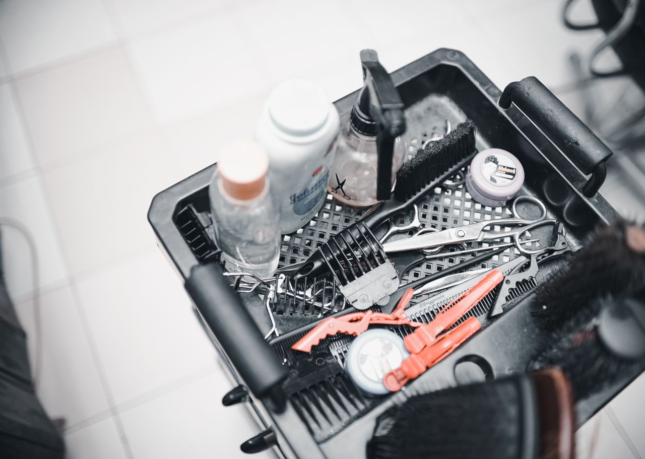 Crafting Captivating Headlines: Your awesome post title goes here A selection of hairdressing tools and products arranged in a salon trolley for professional use.